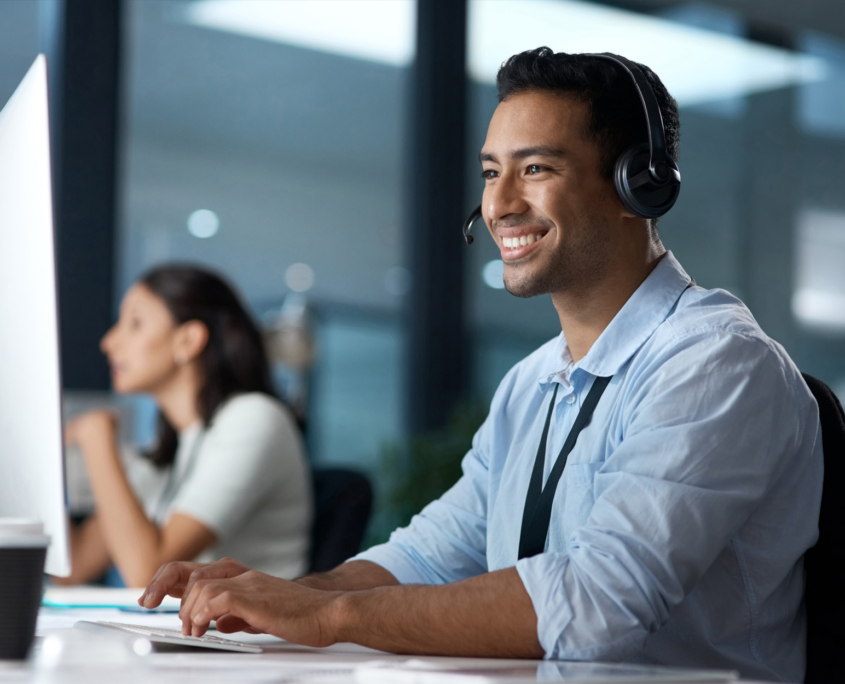 Worker On Computer Talking With Headset